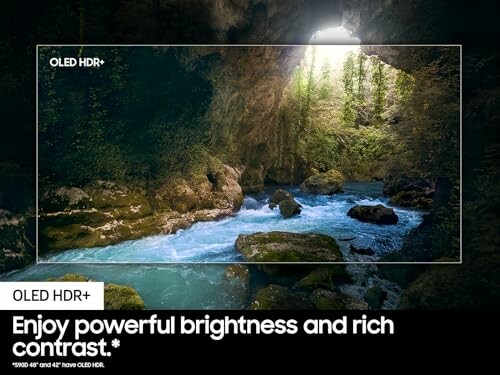 Cave with vibrant blue river demonstrating OLED HDR contrast.
