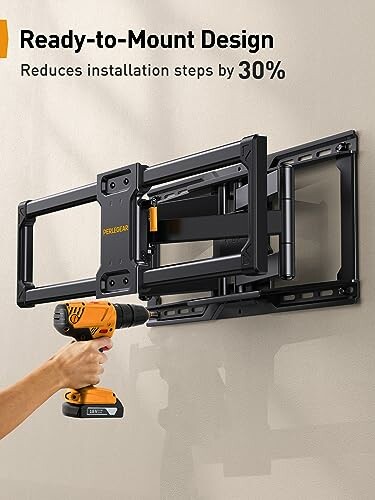 Person using a drill to install a TV wall mount.